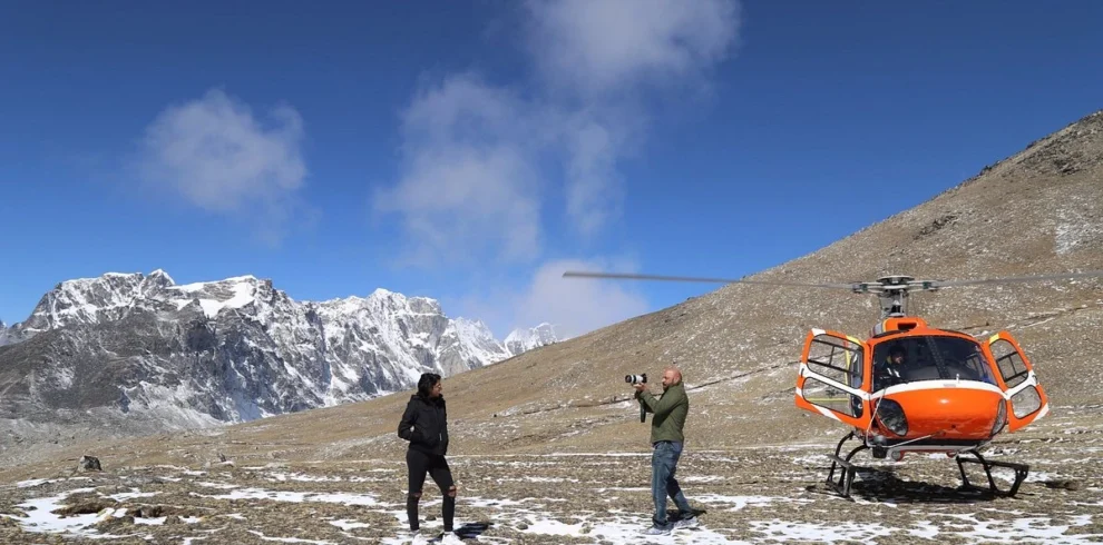 people clicking photo at everest base camp helicopter tour
