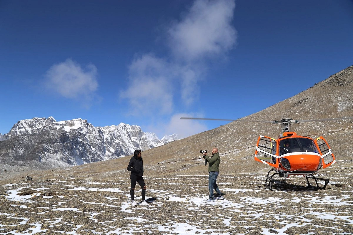 people clicking photo at everest base camp helicopter tour